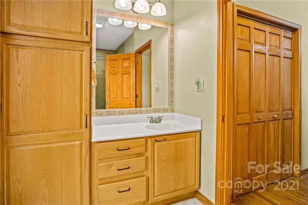74 Apgar Road Candler, NC 28715 - Photo 15 of 46 a bathroom with a granite countertop sink and a mirror