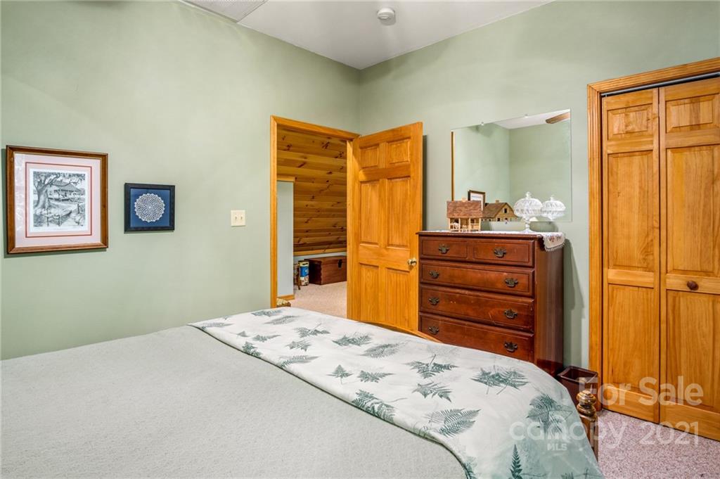74 Apgar Road Candler, NC 28715 - Photo 22 of 46 a bedroom with a bed and dresser
