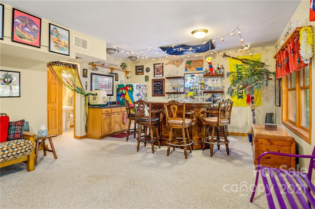 74 Apgar Road Candler, NC 28715 - Photo 24 of 46 a living room filled with furniture and a chandelier