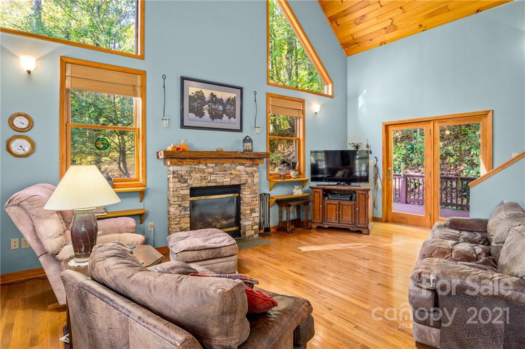 74 Apgar Road Candler, NC 28715 - Photo 3 of 46 a living room with furniture a large window and a fireplace