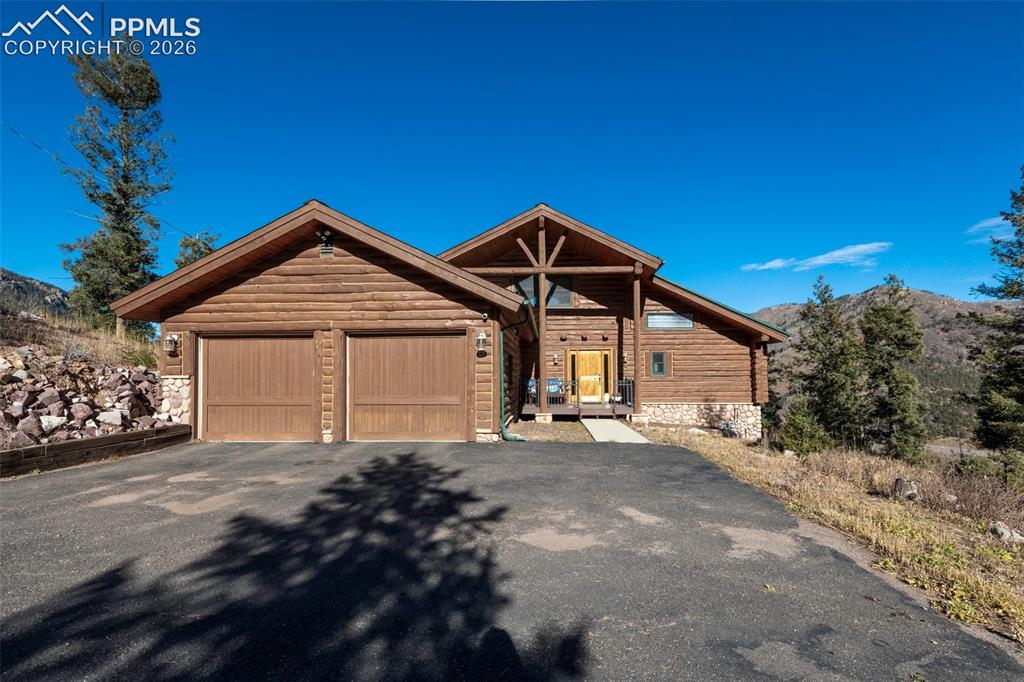 9110 Mountain Road Cascade, CO 80809 - Photo 41 of 49 a front view of a house with a yard