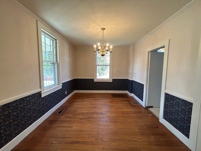 a kitchen with granite countertop white cabinets and refrigerator