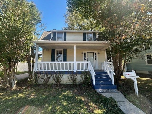 a view of a house with a yard chairs and a table and chair