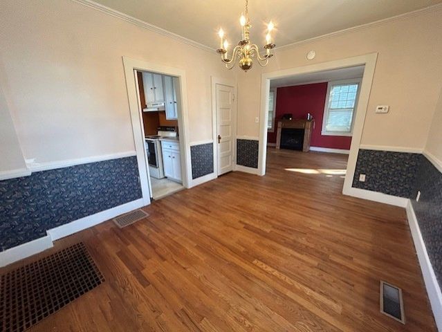 a kitchen with granite countertop a refrigerator stove and sink