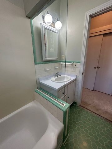 a view of an empty room and wooden floor