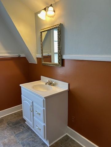 a backyard of a house with trees and outdoor seating