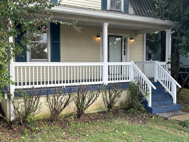 a view of balcony with wooden floor and outdoor seating
