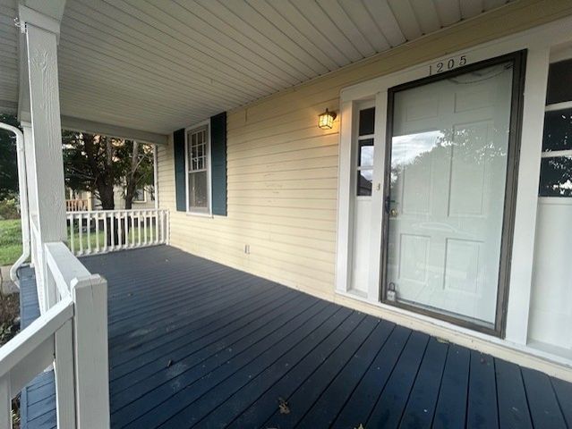 a view of a porch with wooden floor