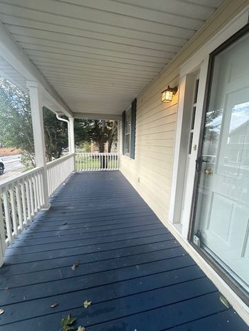 a view of a livingroom with wooden floor and a fireplace