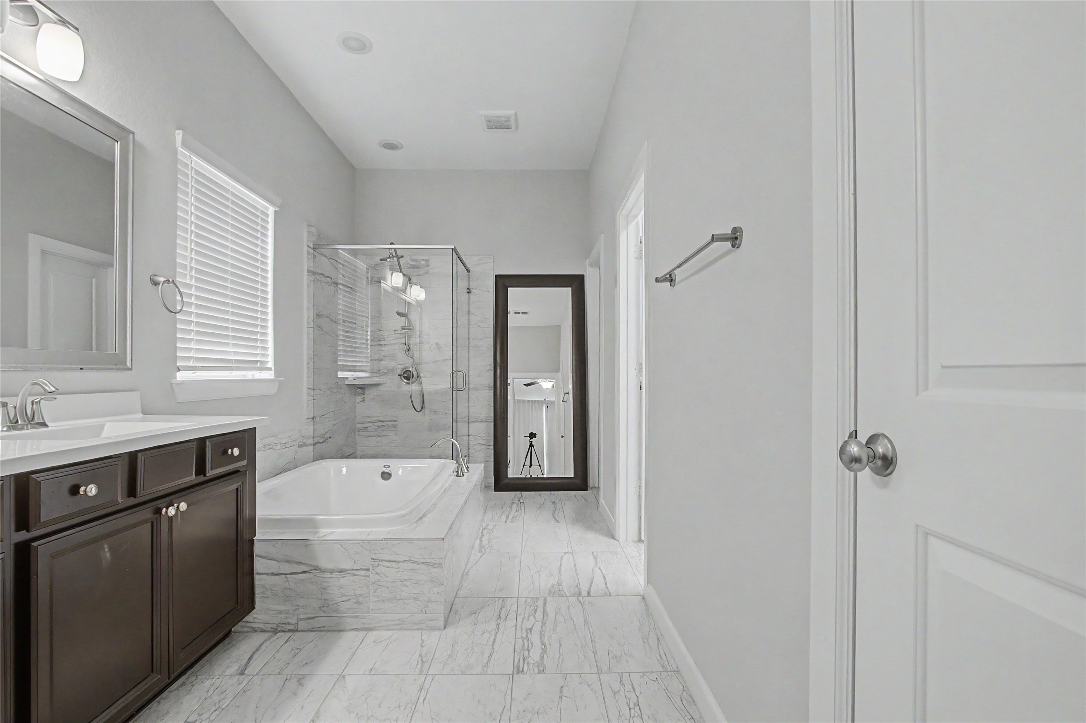 19718 Shinnery Ridge Court Cypress, TX 77433 - Photo 11 of 23 a spacious bathroom with a granite countertop sink a toilet a mirror and shower