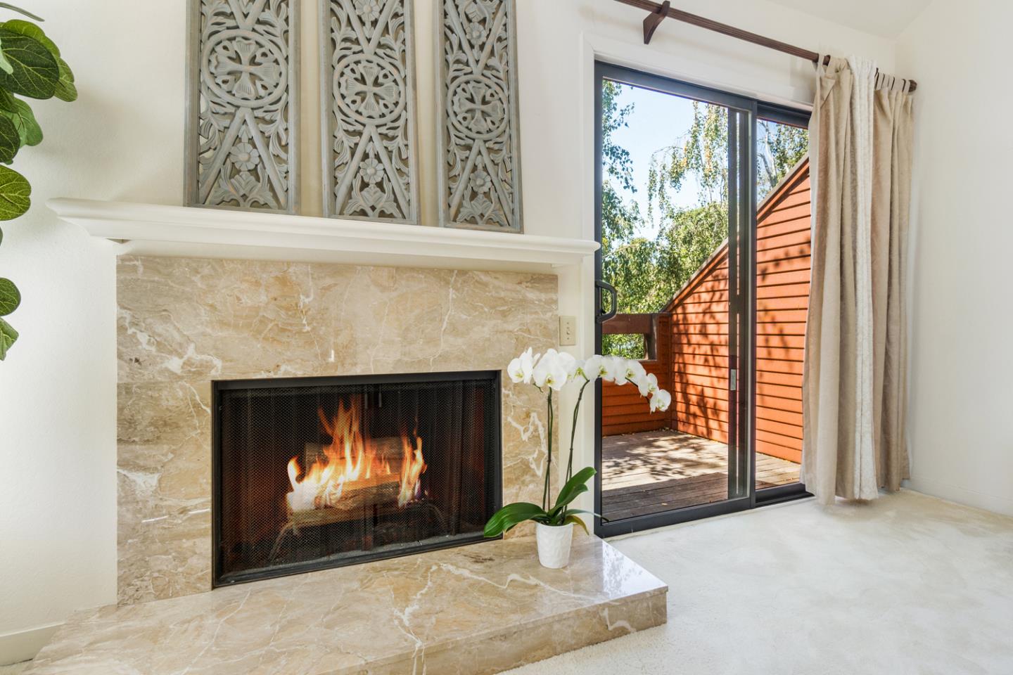 910 Wharfside Road San Mateo, CA 94404 - Photo 19 of 43 a living room with a fireplace and a large window