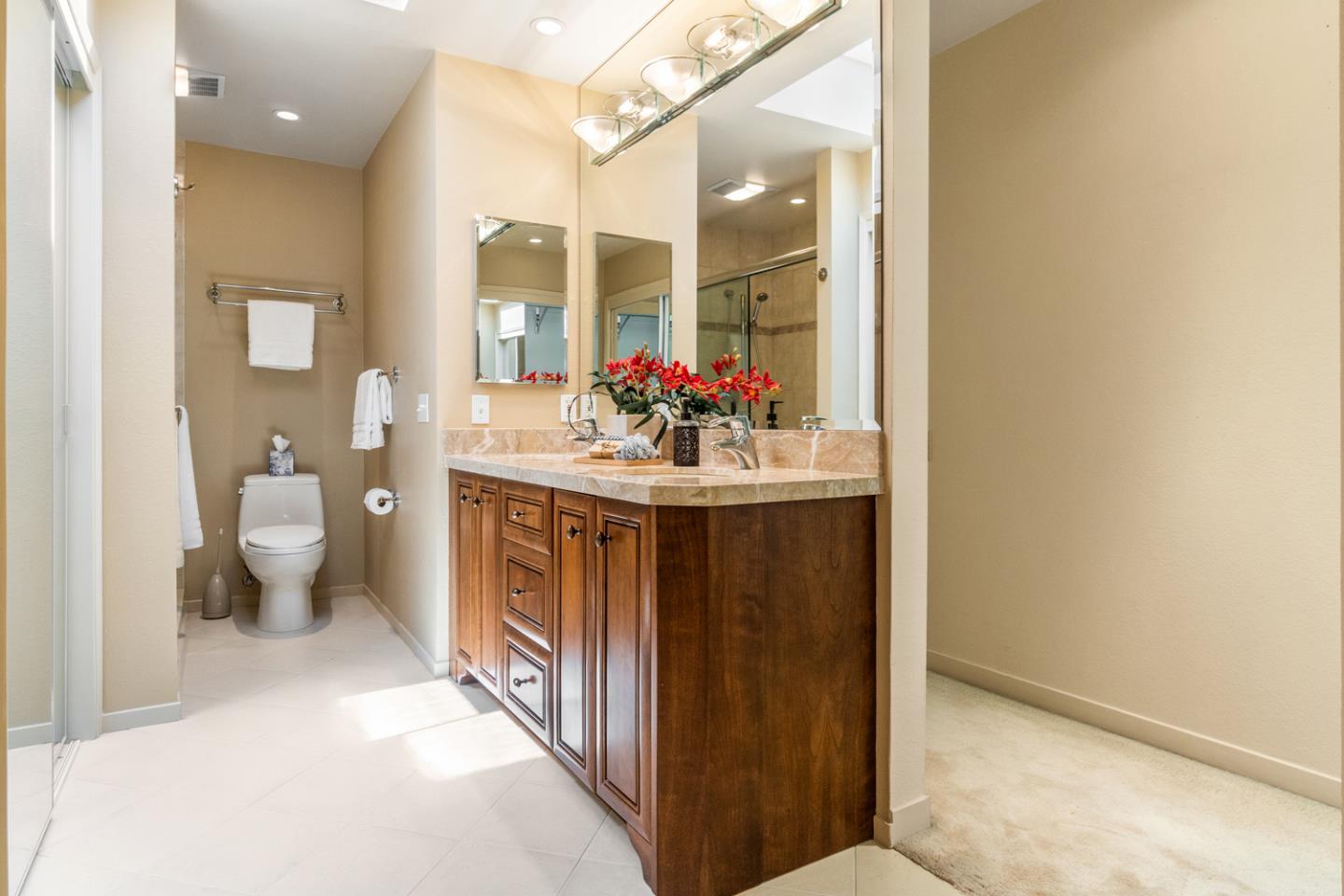 910 Wharfside Road San Mateo, CA 94404 - Photo 24 of 43 a bathroom with a sink vanity mirror and toilet