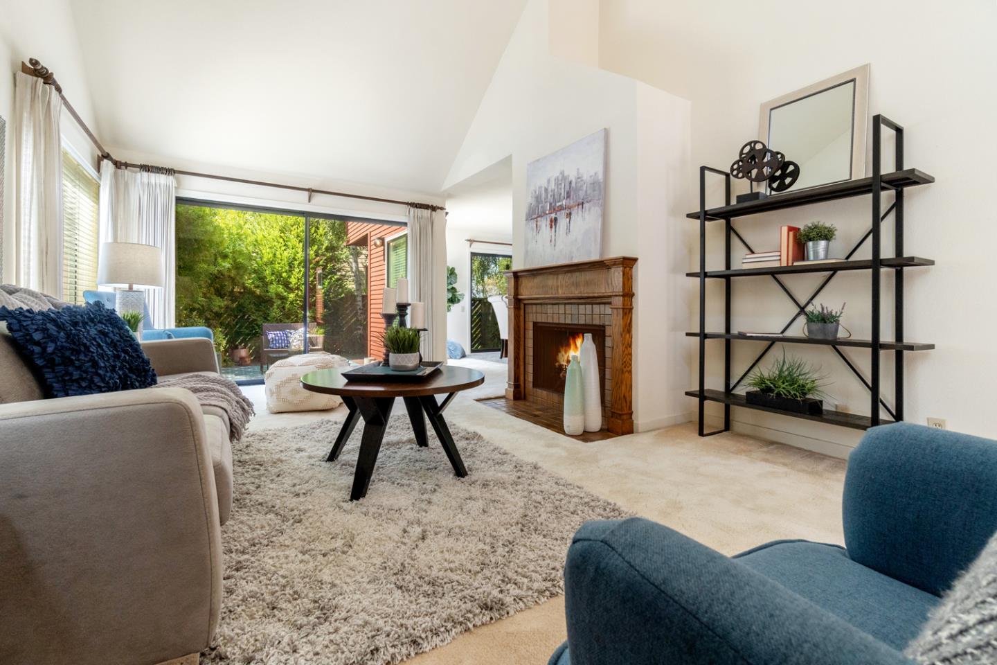 910 Wharfside Road San Mateo, CA 94404 - Photo 5 of 43 a living room with furniture a large window and a fireplace