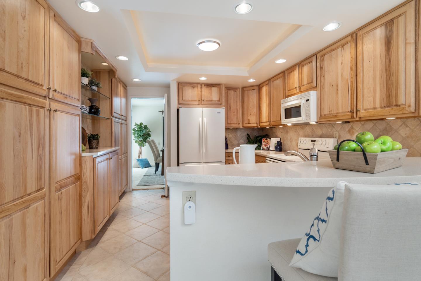 910 Wharfside Road San Mateo, CA 94404 - Photo 9 of 43 a kitchen with stainless steel appliances a refrigerator sink and white cabinets