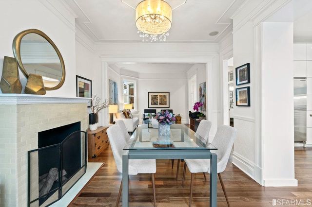 a kitchen with kitchen island white cabinets and stainless steel appliances