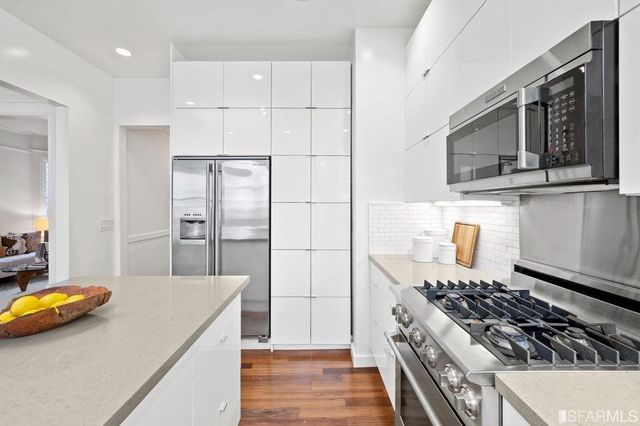 a view of a hallway with wooden floor and a potted plant