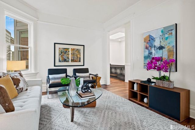 a living room with furniture potted plant and a window