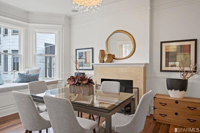a view of dining room and kitchen with furniture wooden floor and a chandelier