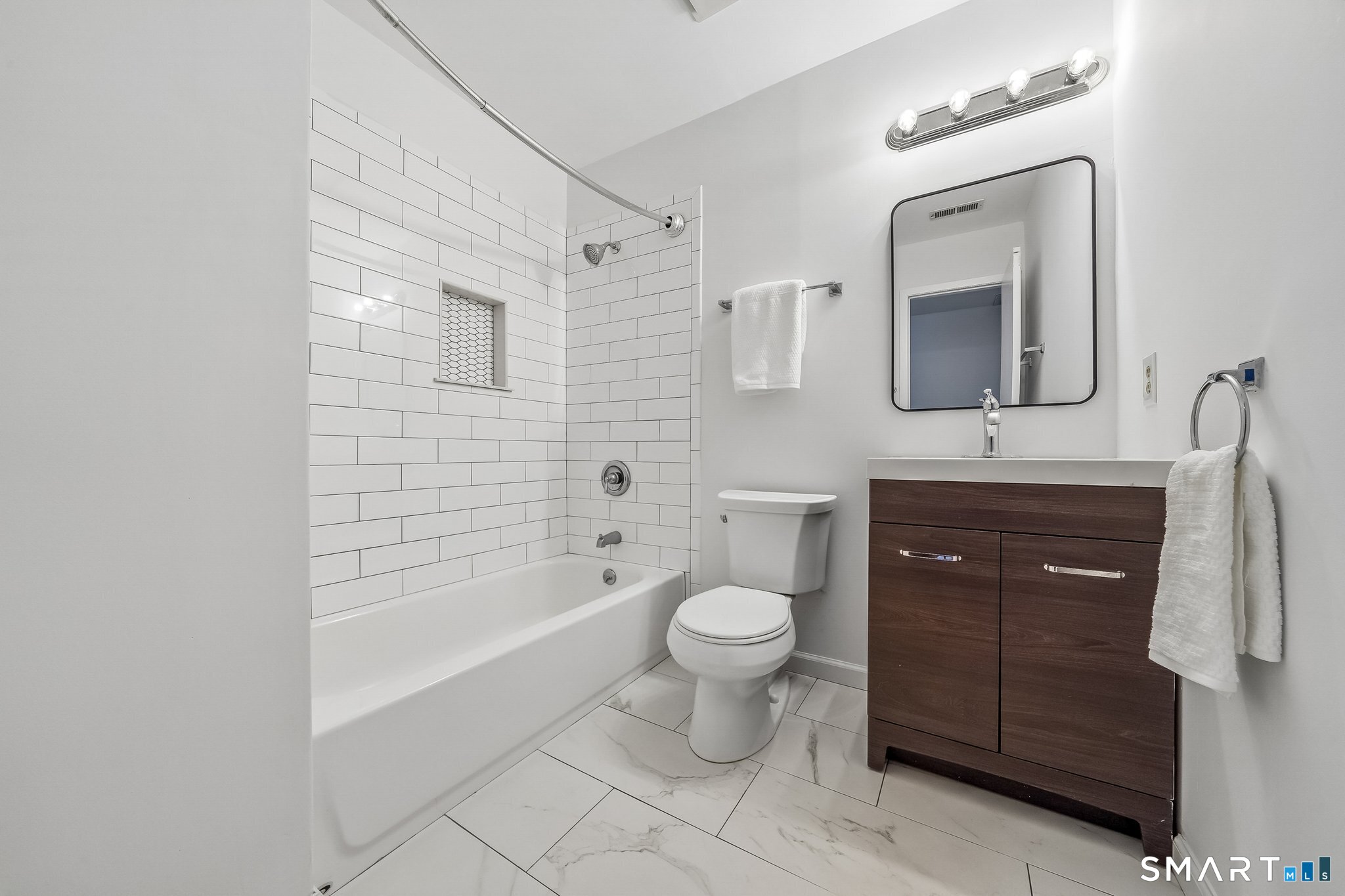 14 Ferris Avenue, Unit 9 Norwalk, CT 06854 - Photo 12 of 20 a bathroom with a toilet sink vanity granite and mirror