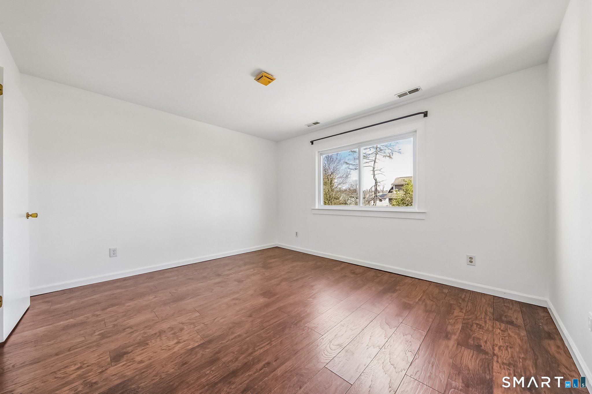 14 Ferris Avenue, Unit 9 Norwalk, CT 06854 - Photo 13 of 20 an empty room with wooden floor and windows