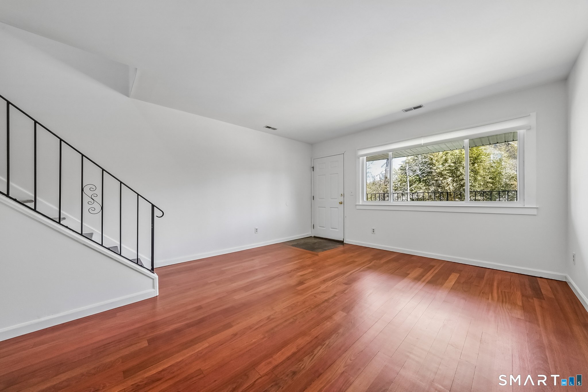 14 Ferris Avenue, Unit 9 Norwalk, CT 06854 - Photo 4 of 20 a view of an empty room with wooden floor and a window