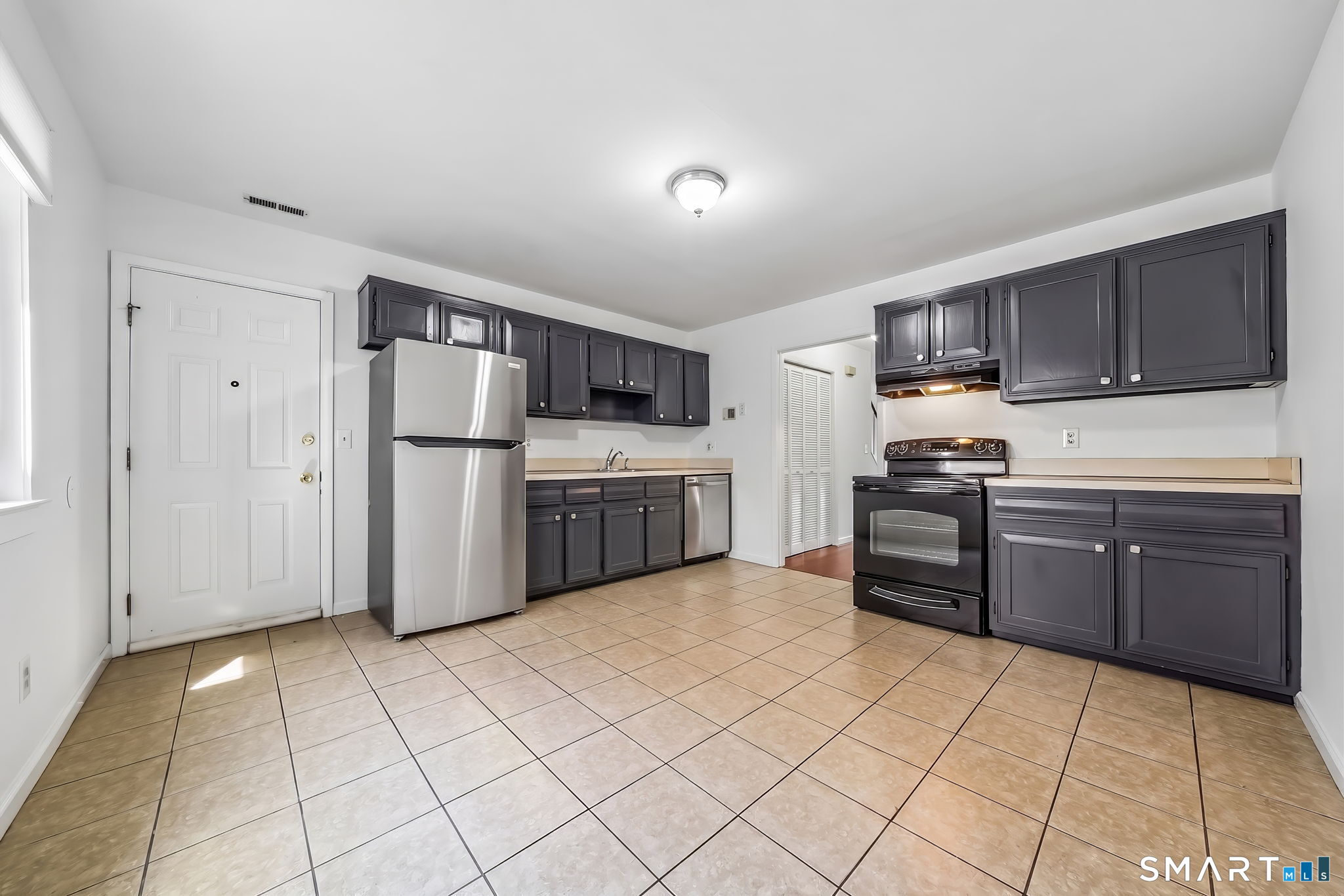 14 Ferris Avenue, Unit 9 Norwalk, CT 06854 - Photo 5 of 20 a kitchen with stainless steel appliances granite countertop a stove refrigerator and cabinets