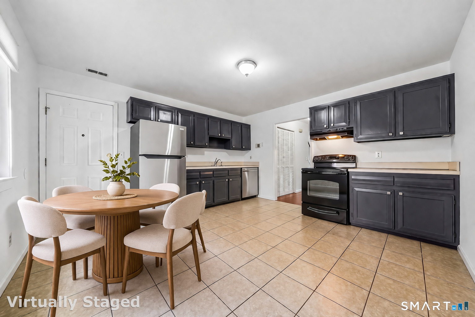 14 Ferris Avenue, Unit 9 Norwalk, CT 06854 - Photo 6 of 20 a kitchen with stainless steel appliances kitchen island granite countertop a stove a sink a dining table and chairs