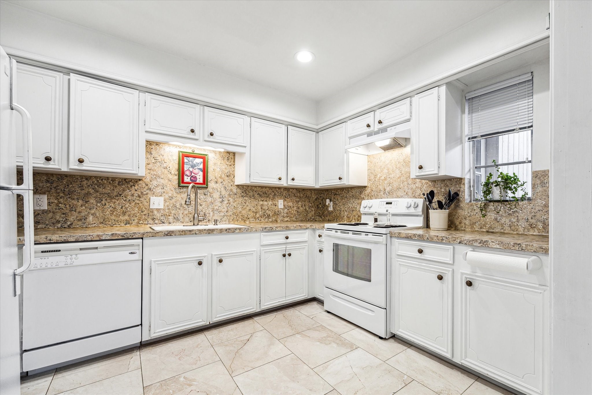 1880 Saxony Lane Houston, TX 77058 - Photo 14 of 38 a kitchen with granite countertop white cabinets white appliances with a sink and dishwasher