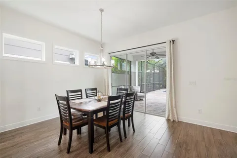 a living room with furniture and a large window with kitchen view