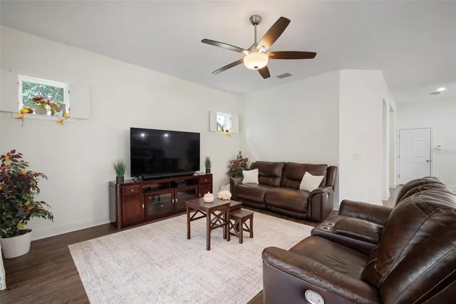 a view of a workspace with furniture and wooden floor