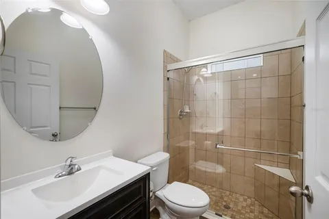 a bedroom with a large bed and a flat tv screen