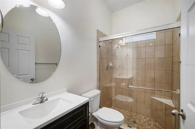 a bedroom with a large bed and a flat tv screen