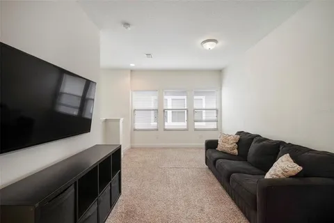 a bedroom with a large bed and a flat tv screen