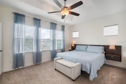 a bathroom with a granite countertop sink a large mirror and a bathtub