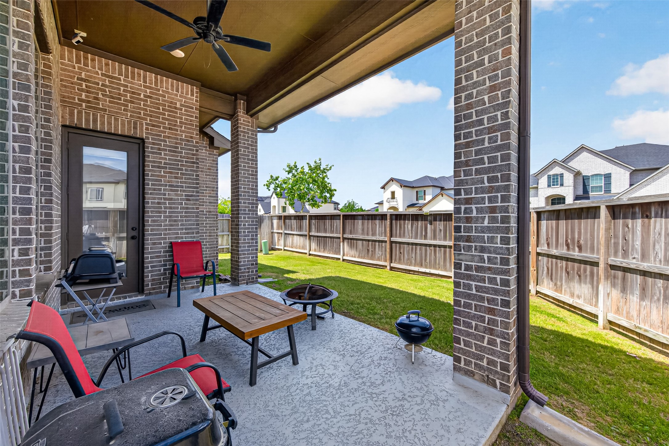 20802 Mirror Point Drive Cypress, TX 77433 - Photo 32 of 37 This cozy covered patio, featuring brick pillars, offers ample space for outdoor seating and opens to a fenced backyard, perfect for family and friends.