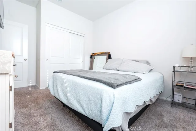 a bedroom with a bed and a book shelf