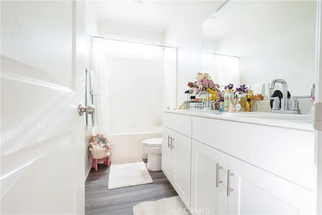 a bathroom with a sink mirror vanity and toilet