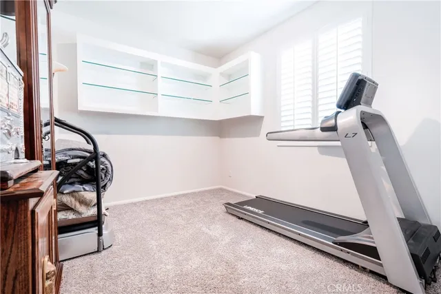 a spacious bedroom with a bed and a dresser