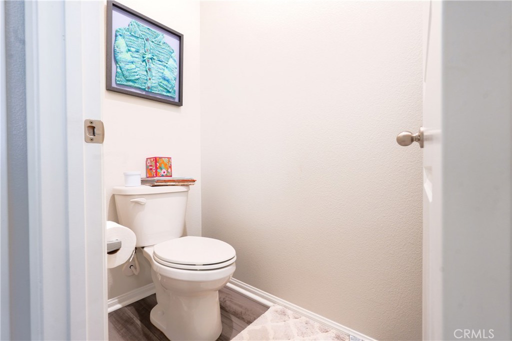15630 Raptor Road Moreno Valley, CA 92551 - Photo 22 of 25 a white toilet sitting next to a bathroom sink