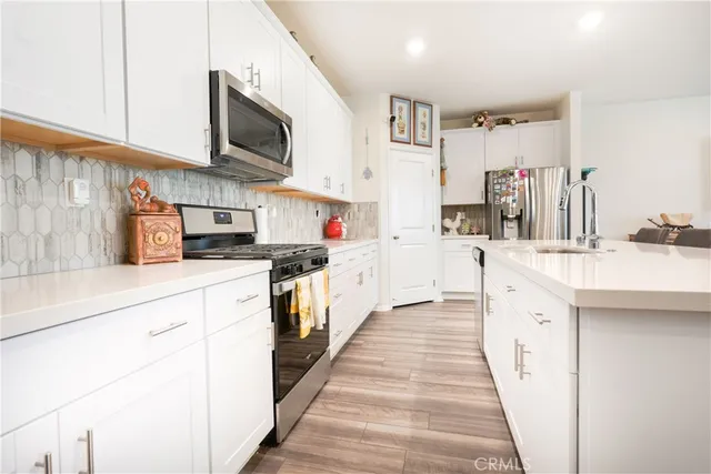 a kitchen with stainless steel appliances a sink and cabinets