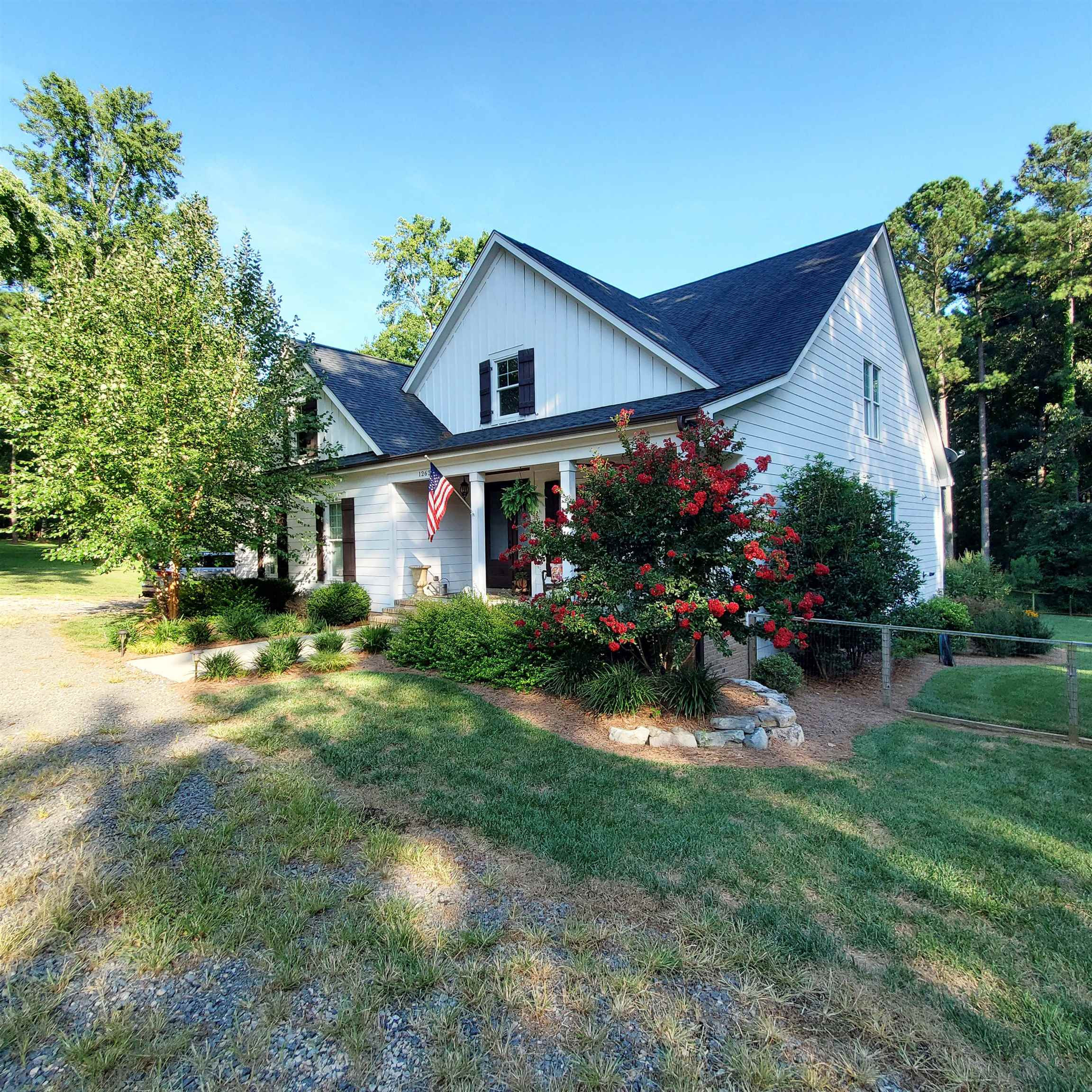 12628 Old Creedmoor Road Raleigh, NC 27613 - Photo 29 of 32 a front view of a house with garden