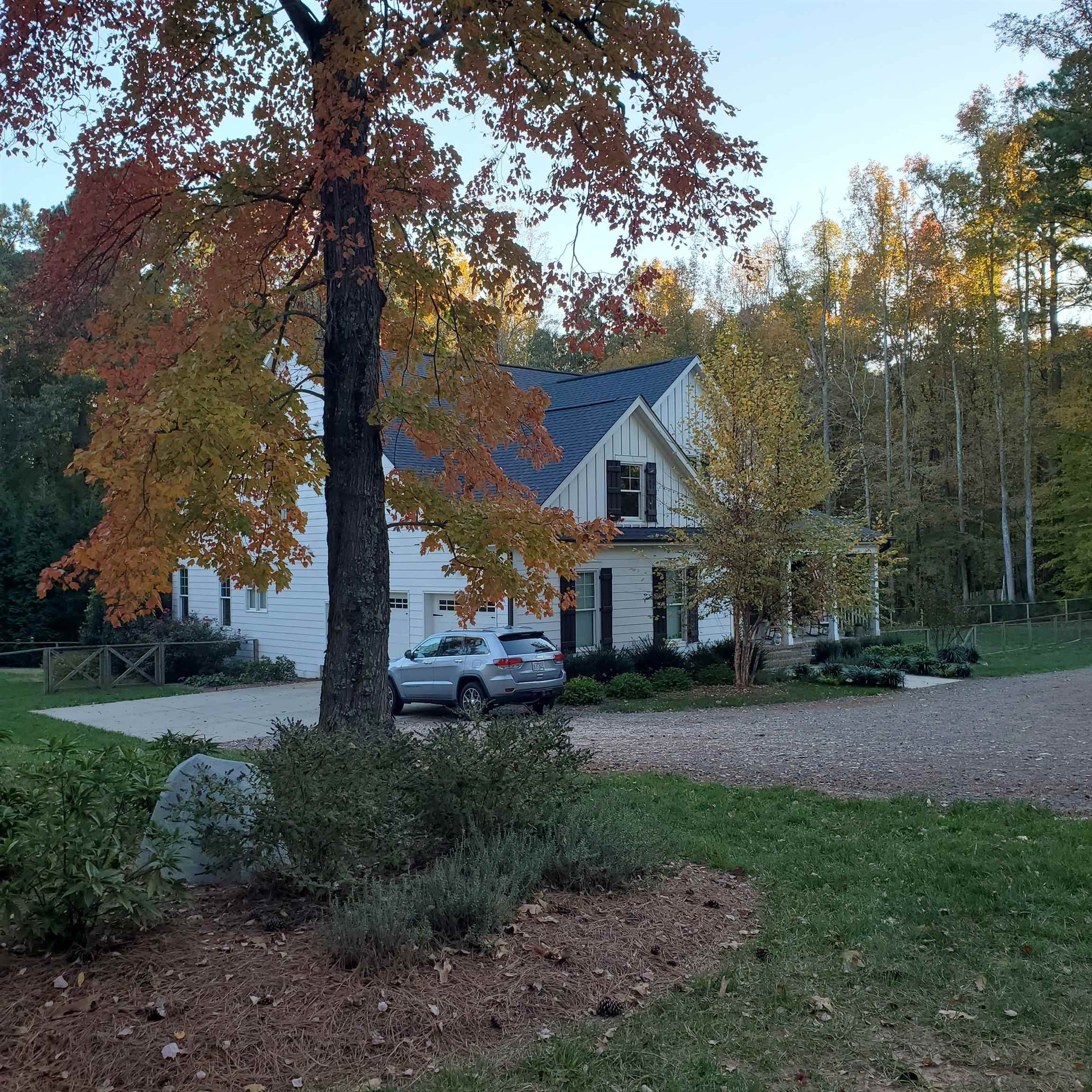 12628 Old Creedmoor Road Raleigh, NC 27613 - Photo 30 of 32 a view of a big house with a big yard and large trees