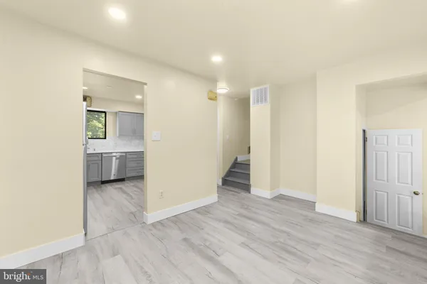 a view of a hallway with wooden floor and closet