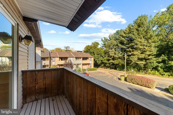 a balcony with wooden floor and city view