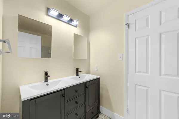 a bathroom with a double vanity sink and mirror