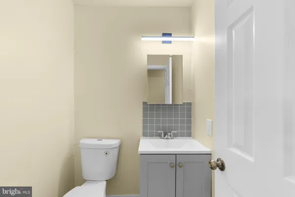a bathroom with a sink a toilet and mirror