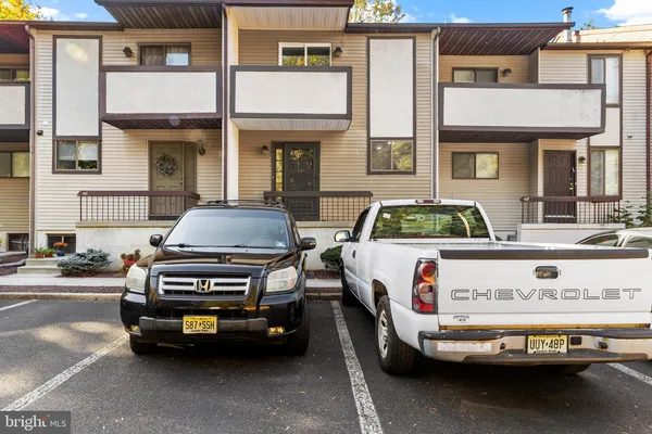 a car parked in front of a brick house
