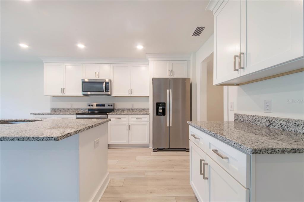 500 9th Street Northeast Fort Meade, FL 33841 - Photo 13 of 33 a kitchen with stainless steel appliances granite countertop a refrigerator a stove and a sink