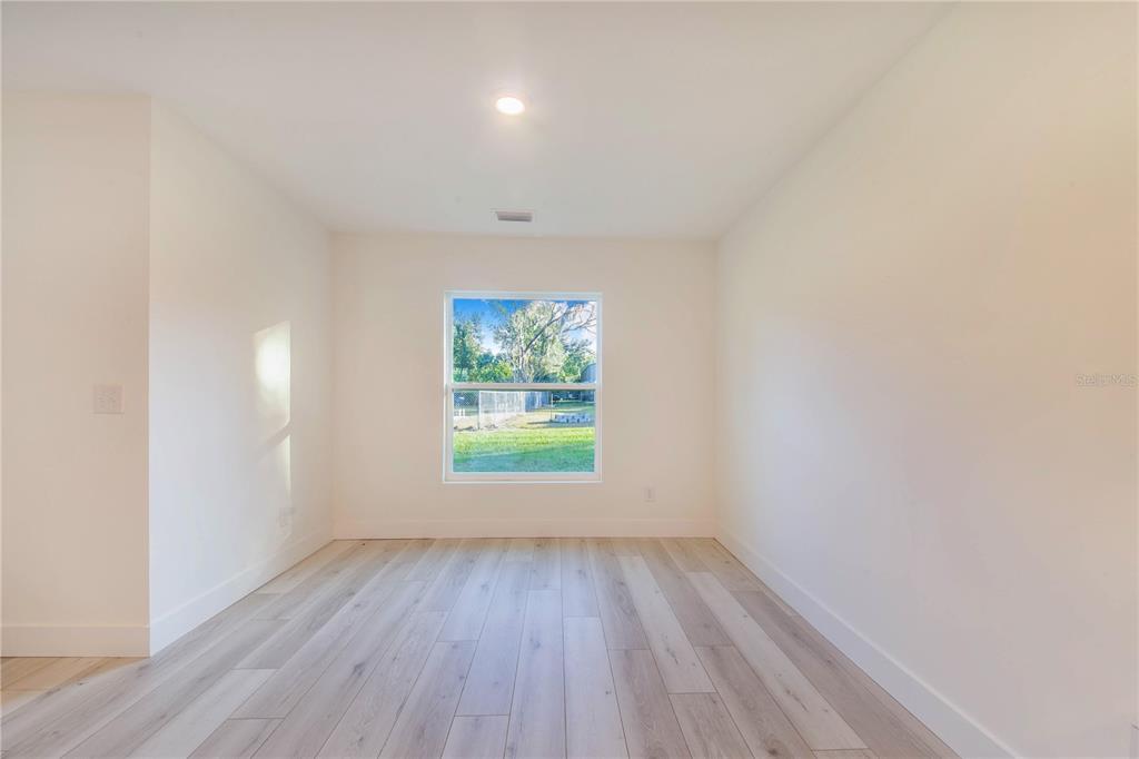500 9th Street Northeast Fort Meade, FL 33841 - Photo 15 of 33 an empty room with wooden floor and window