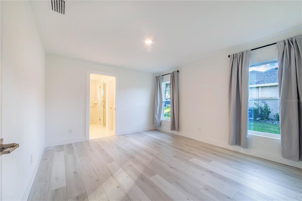 500 9th Street Northeast Fort Meade, FL 33841 - Photo 20 of 33 an empty room with wooden floor and windows